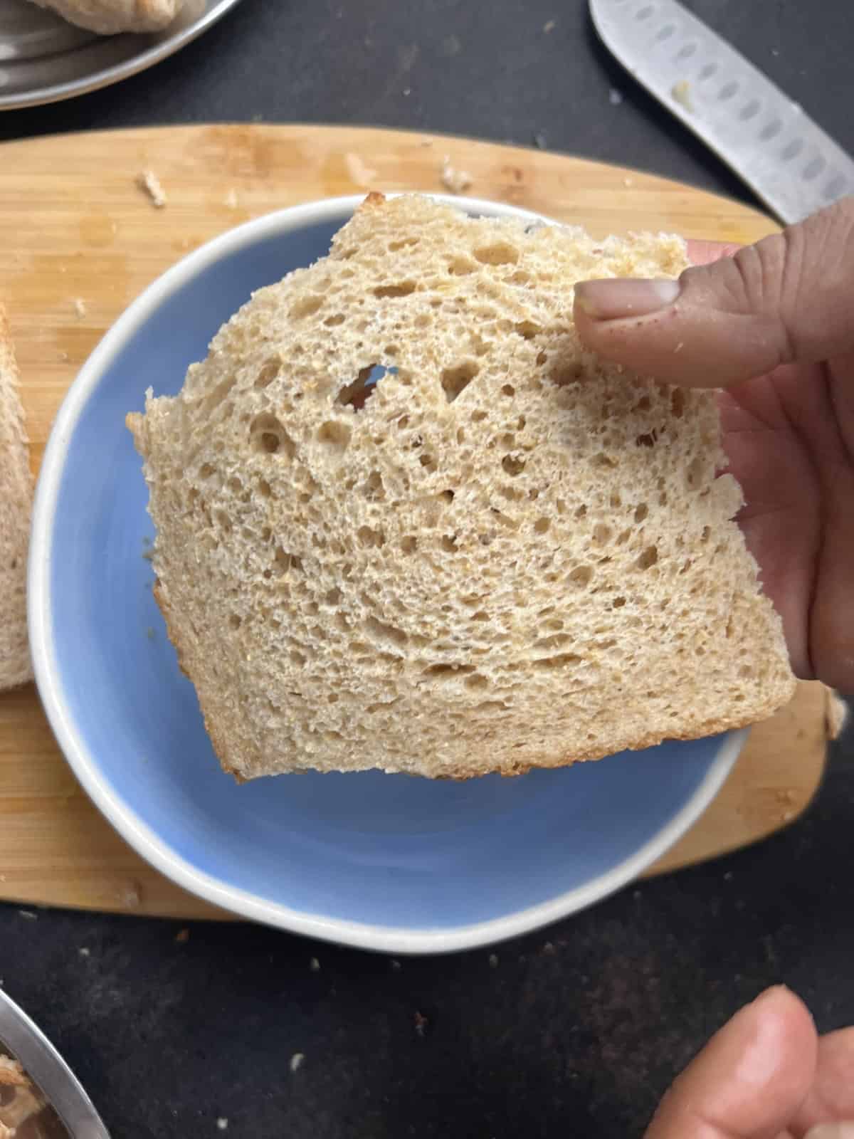 Whole wheat bread slice trimmed and ready for shaping stuffed bread rolls