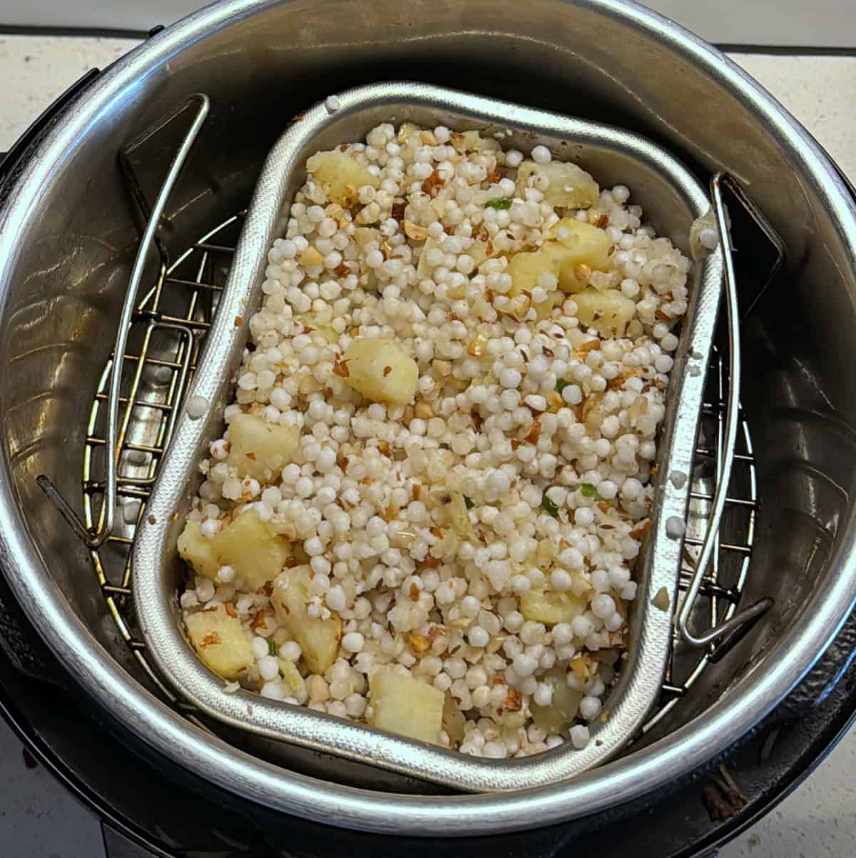 Step 5: Sabudana khichdi with potatoes and peanuts air fried until sabudana turns translucent and evenly cooked.