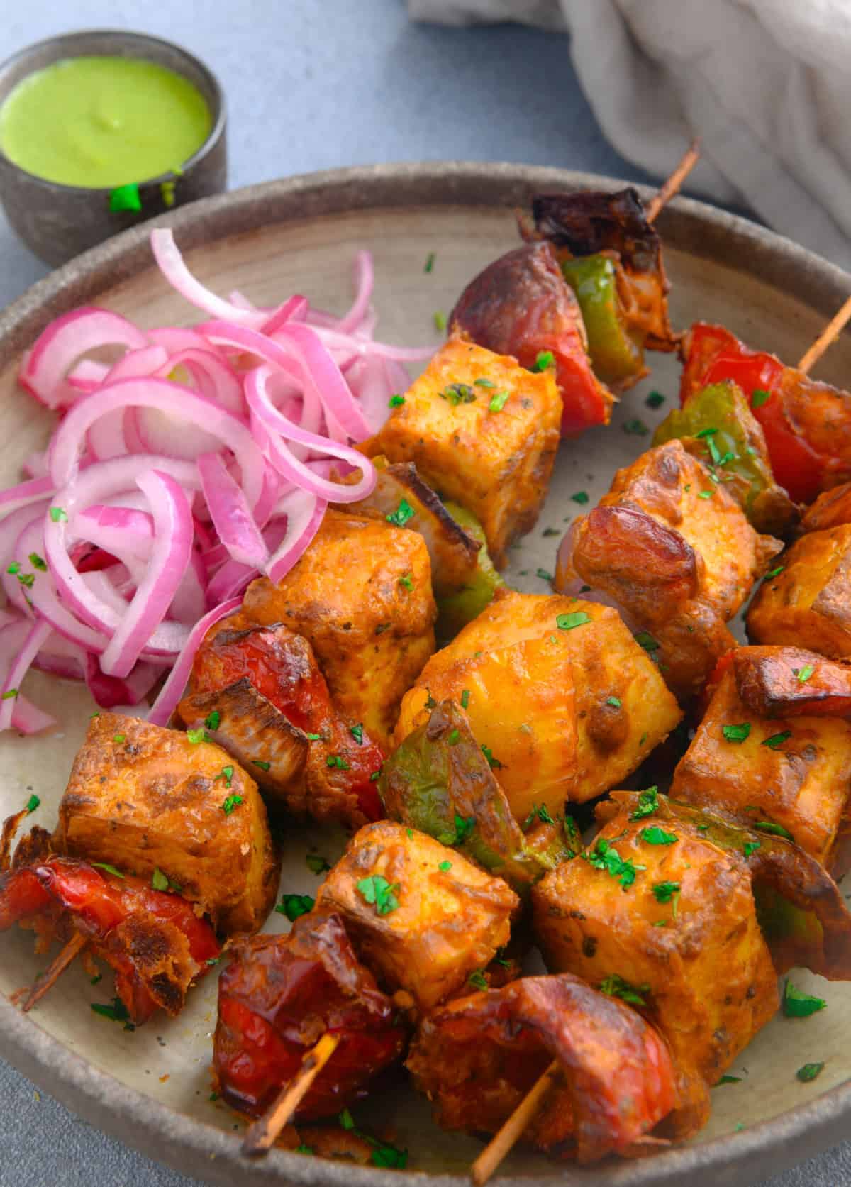 Tandoori tofu tikka skewers in air fryer basket