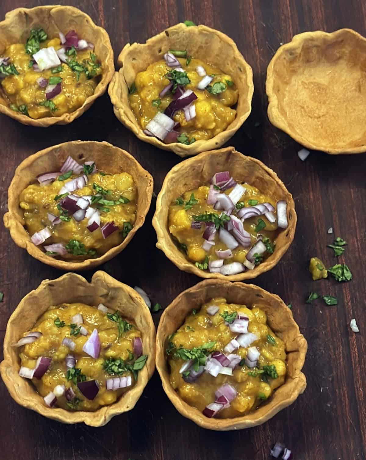 Serve dal in crisp air-fried katoris topped with chutneys, onions, and spices.