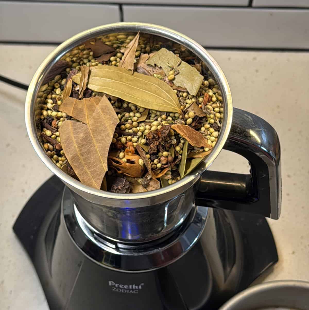 Air-roasted spices cooling in a bowl after air frying.