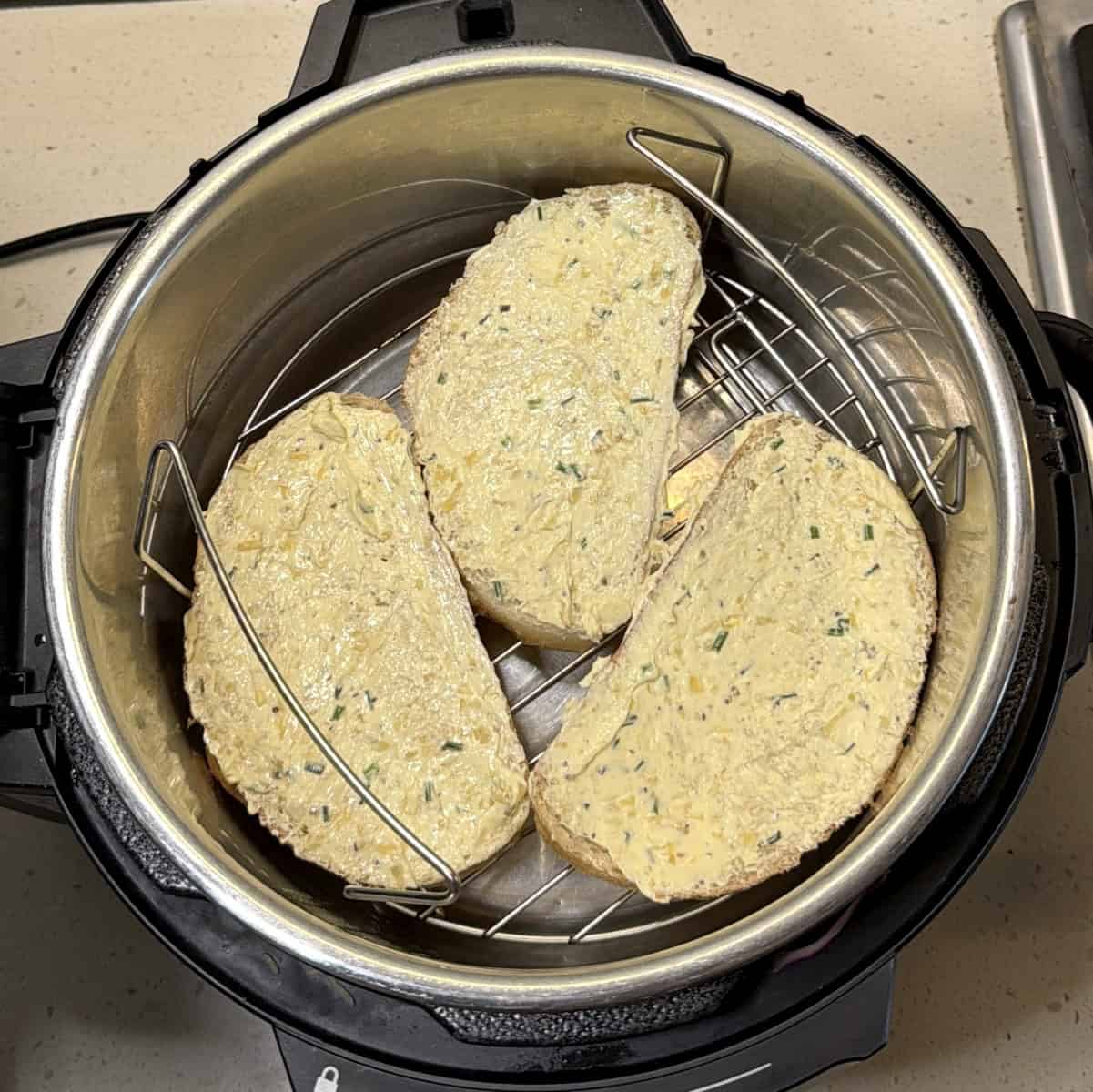 Buttered bread slices placed in air fryer basket
