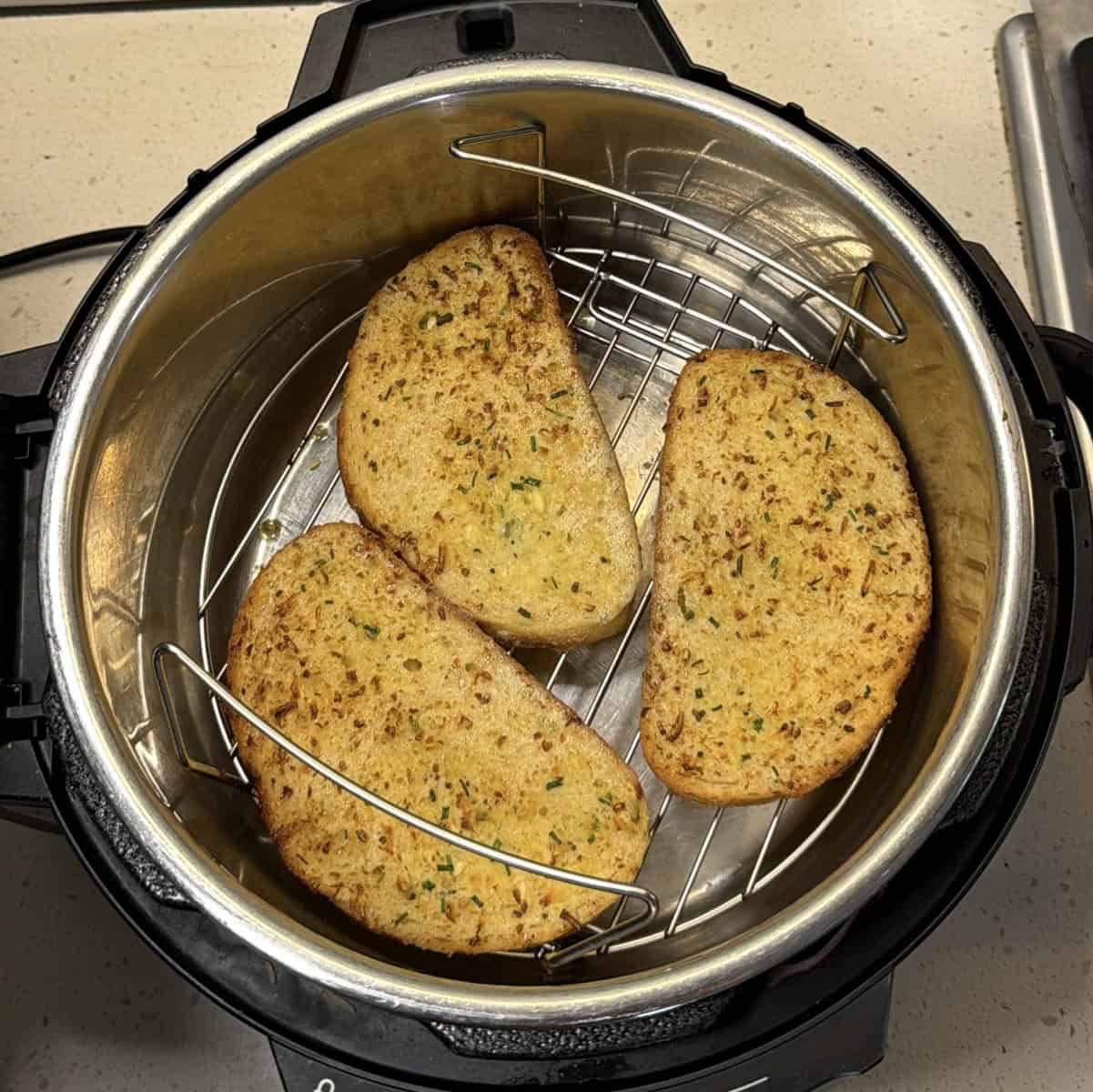 Golden garlic bread slices after air frying