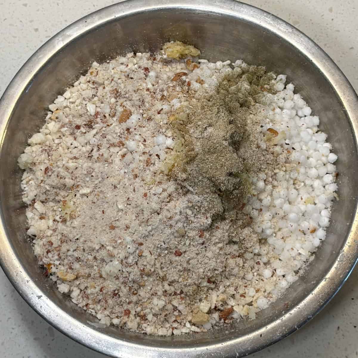 Add soaked sabudana, spices, and seasonings to the makhana mixture, mix to combine