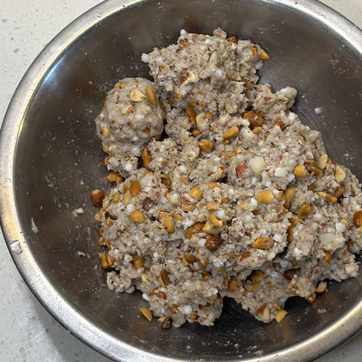 Mix the makhana tikki mixture until it binds, shape a portion to test the texture.