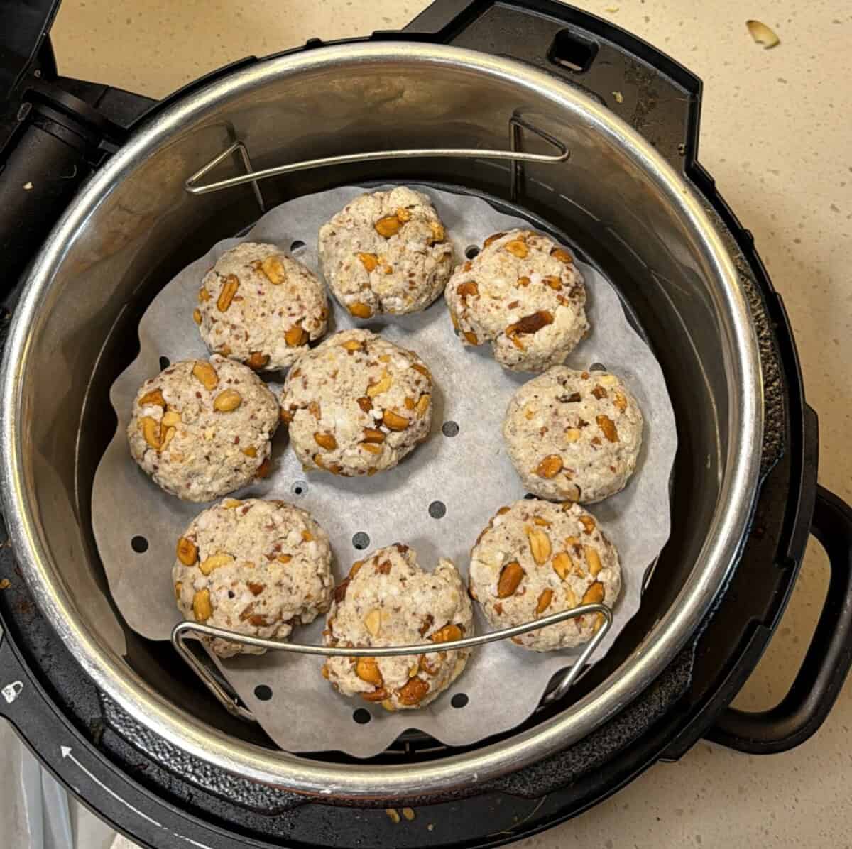 Add shaped makhana tikkis to a lined air fryer basket, keep space between each piece.