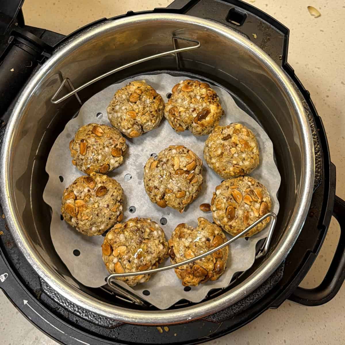Flip the makhana tikkis halfway, brush lightly with oil, air fry until lightly golden.