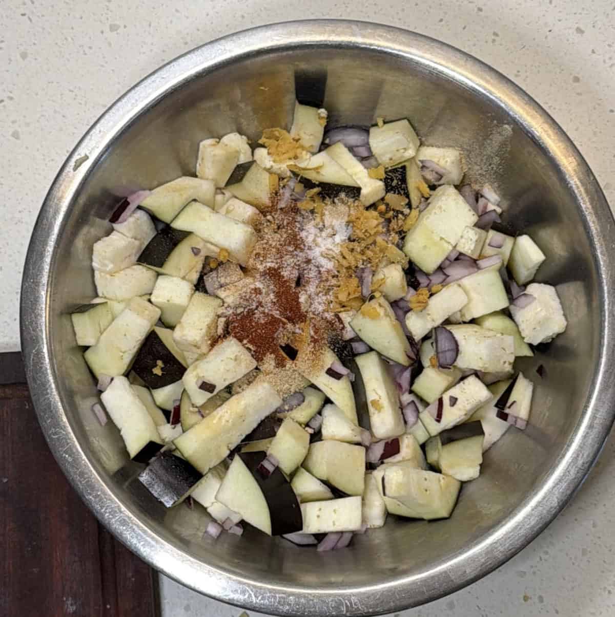 Chopped eggplant and onion mixed with spices for air fryer eggplant pakora