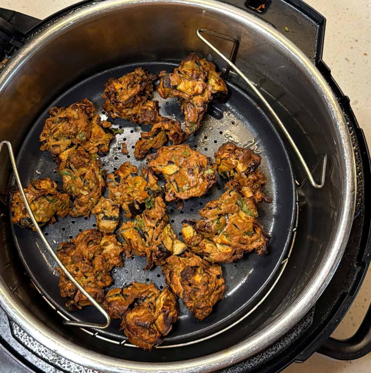 Crispy air fryer eggplant pakora in air fryer basket