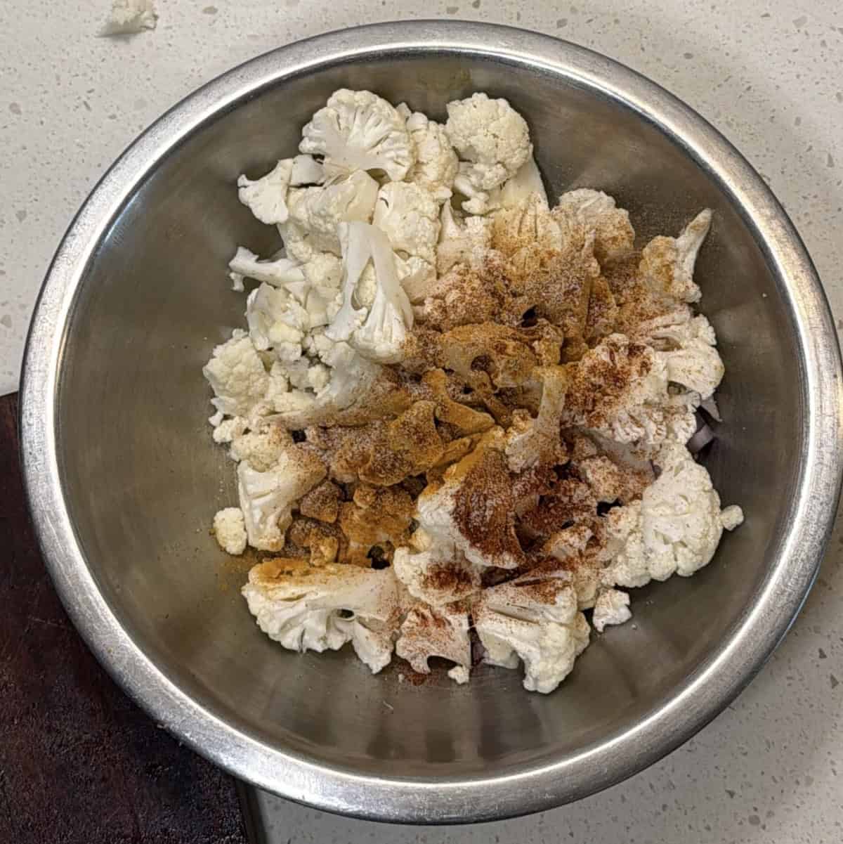 Cauliflower florets with spices for gobi pakora in air fryer