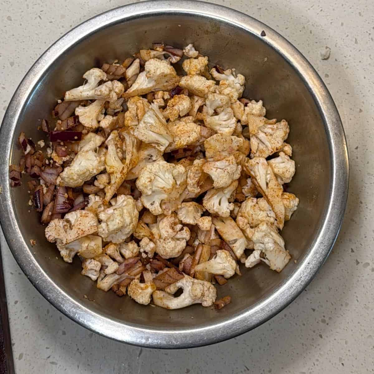 Cauliflower and onion mixed with spices for air fryer gobi pakora