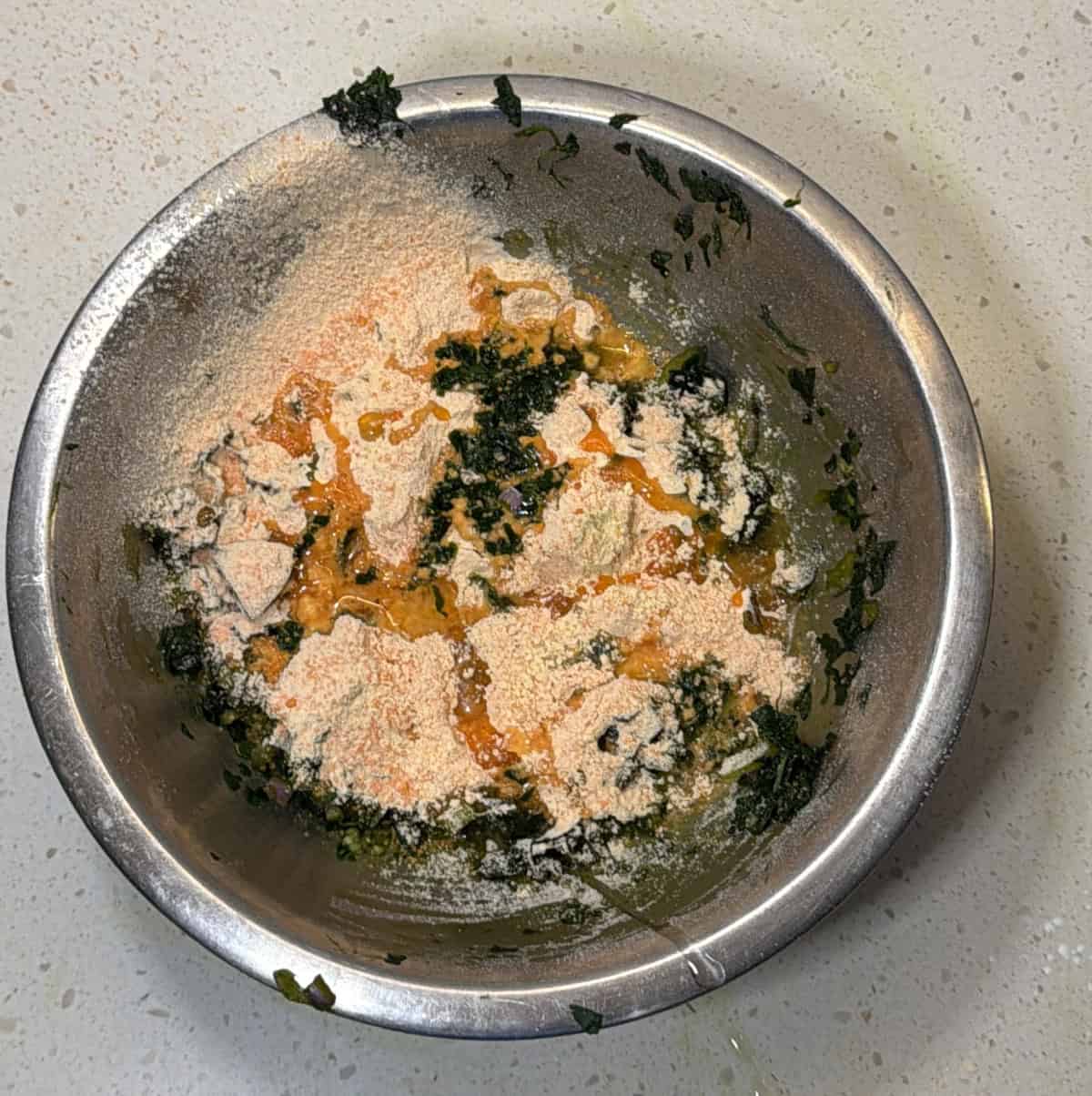 Red lentil flour and besan added to spinach pakora mixture