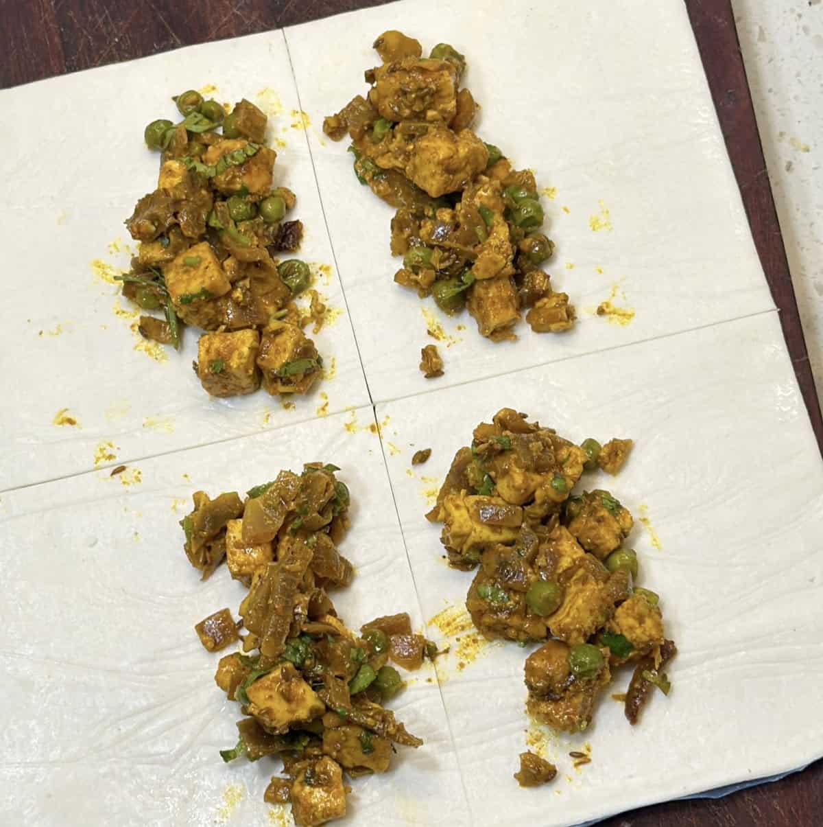 Paneer filling placed on puff pastry sheets for air fryer paneer puffs