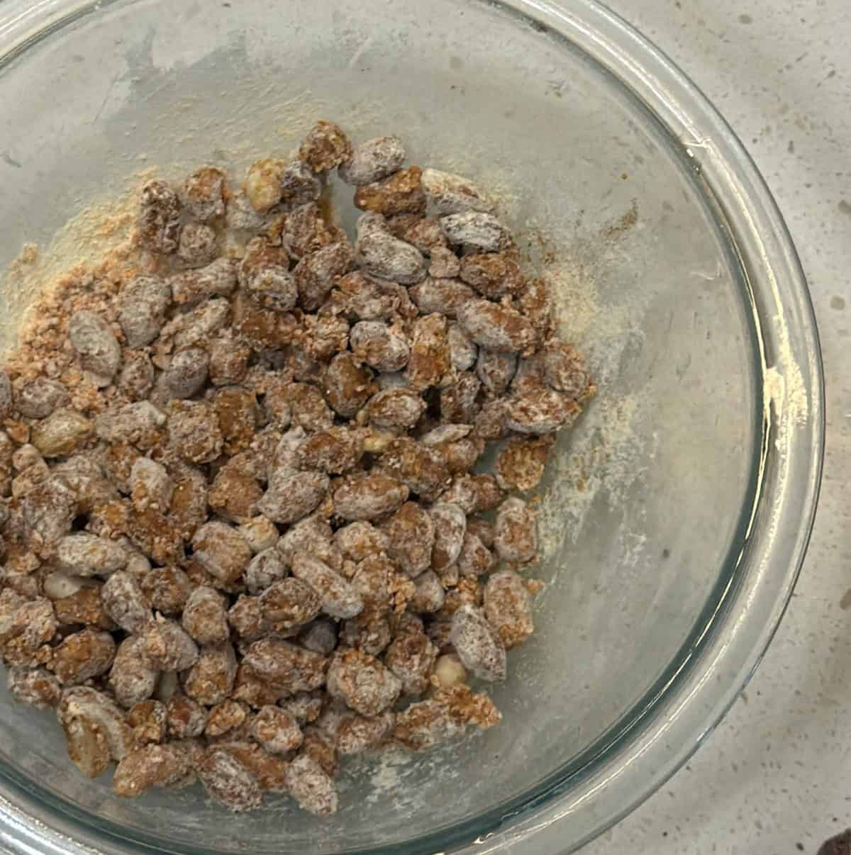Peanuts evenly coated with red lentil flour and masala spices