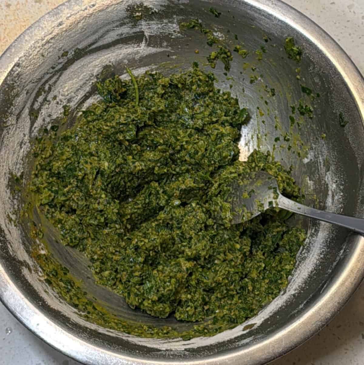 Methi pakora portions on baking paper in air fryer basket