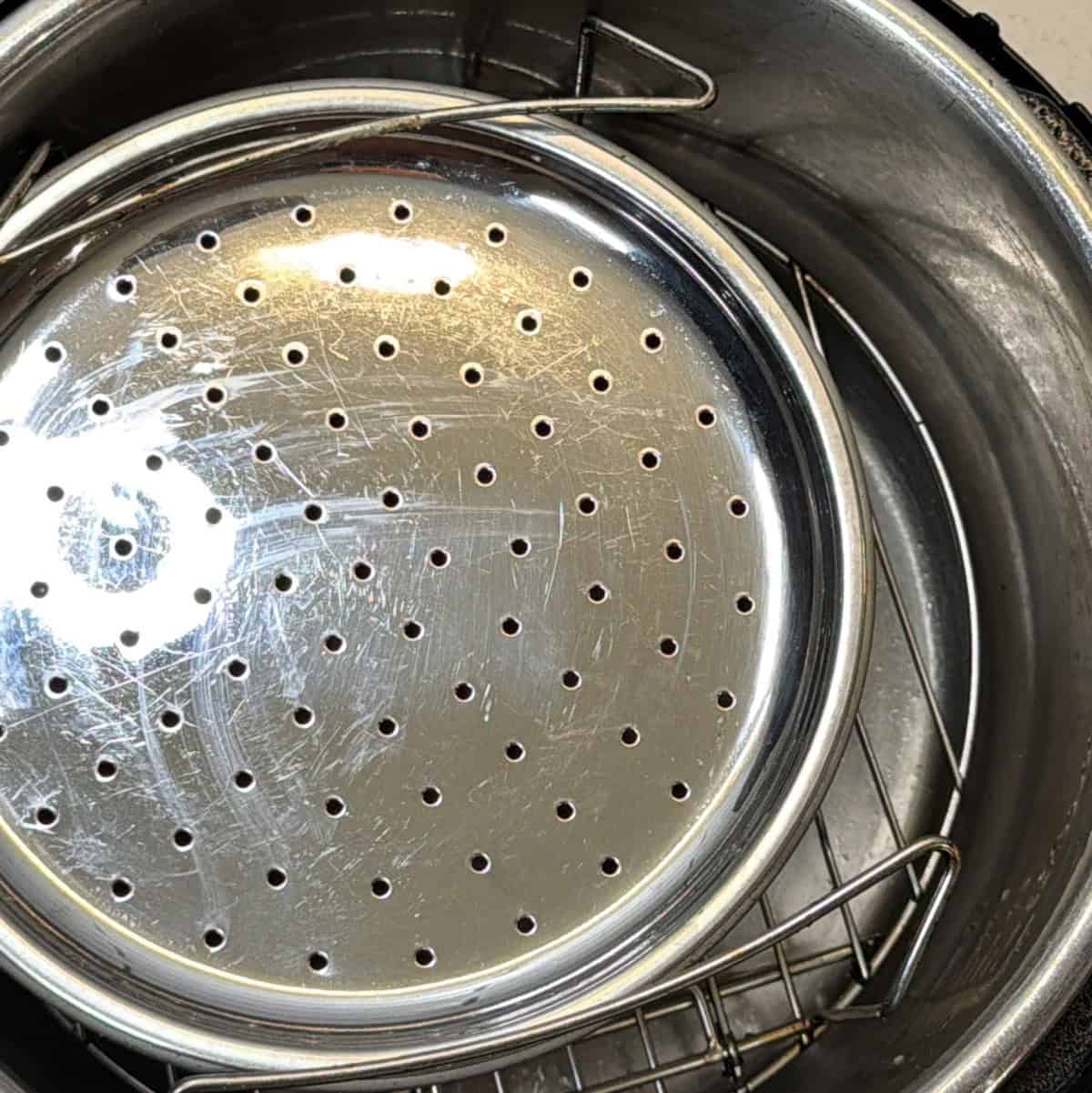 perforated metal tray covering oat flour mixture in air fryer