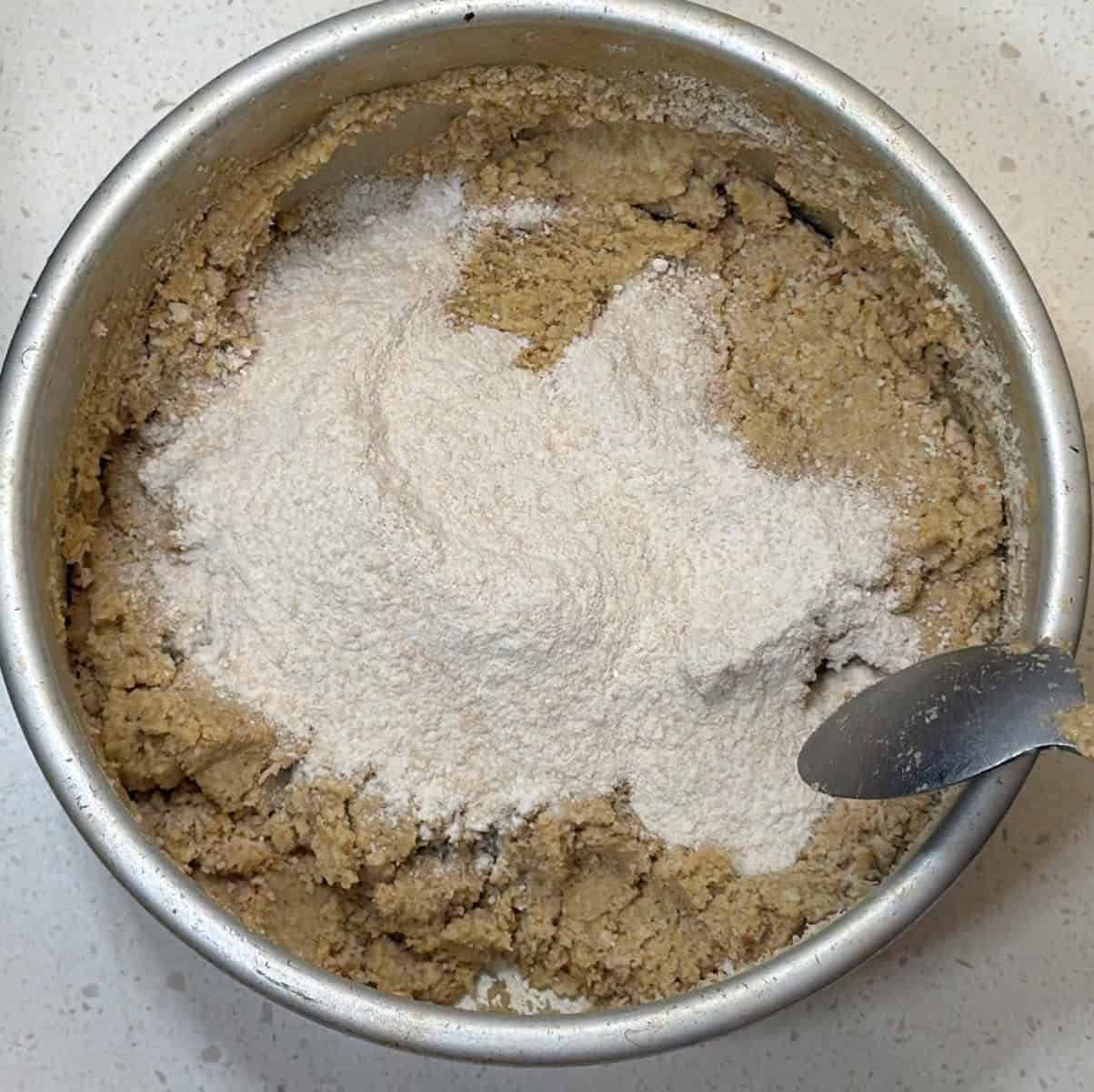 powdered sugar added to roasted oats ladoo mixture