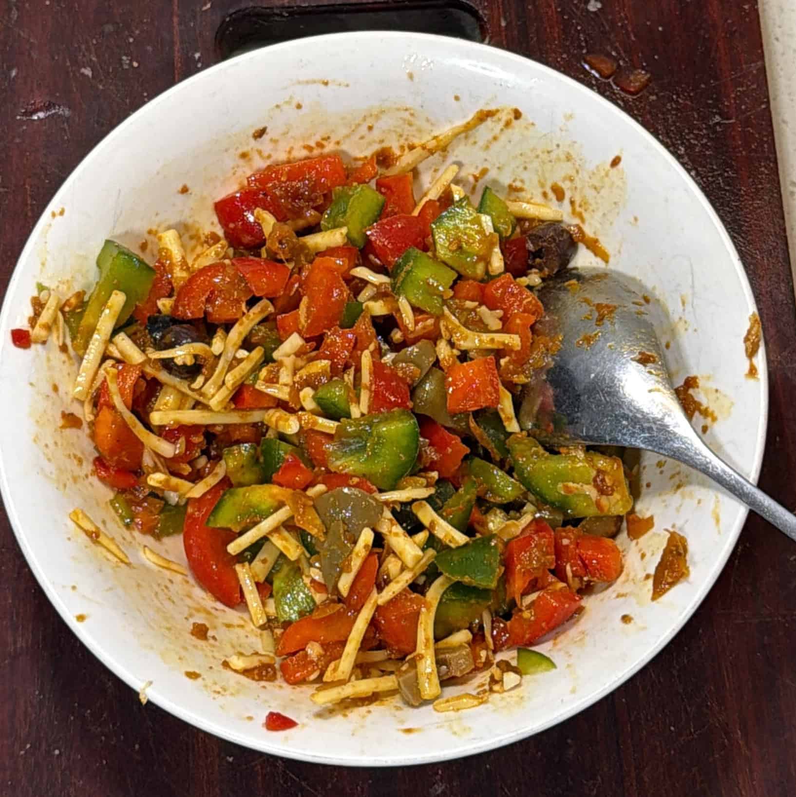Pizza puff filling mixed with peppers, pizza sauce, olives and cheese