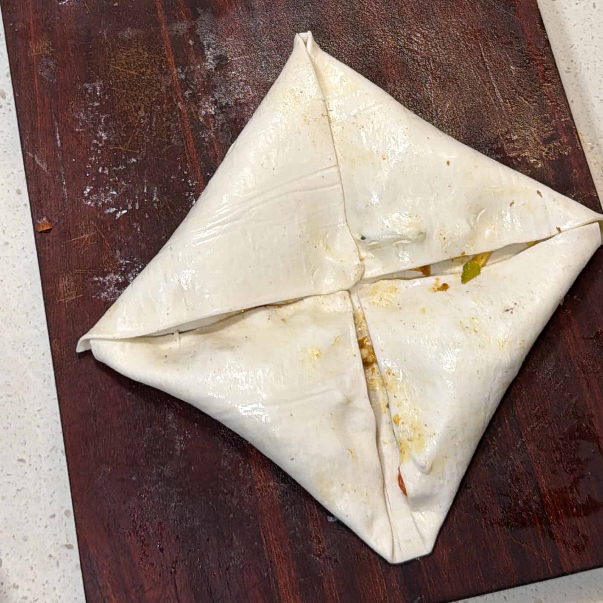 Puff pastry folded into an envelope for homemade pizza puffs