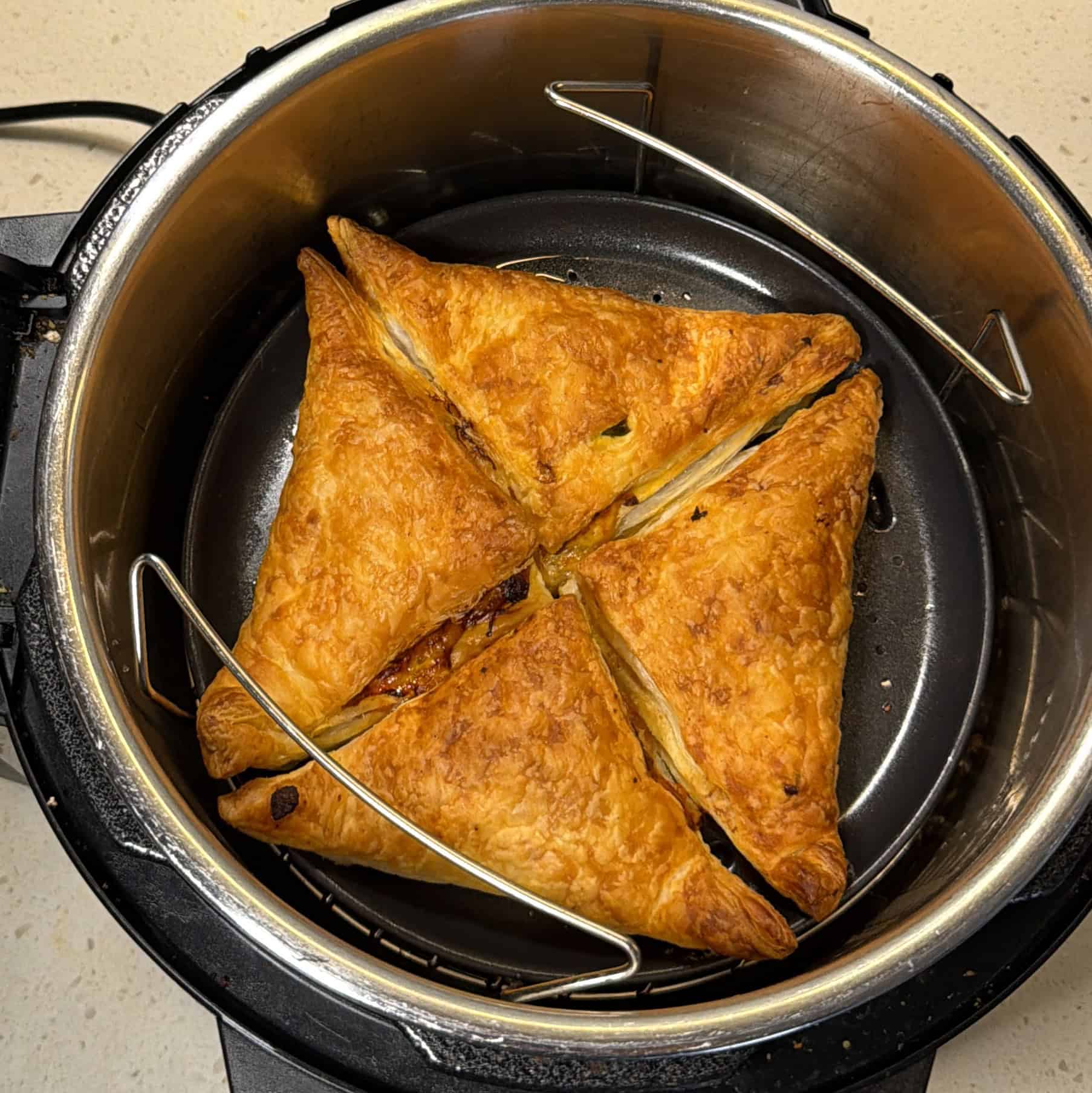 Golden crispy air fryer pizza puffs cooked with puff pastry