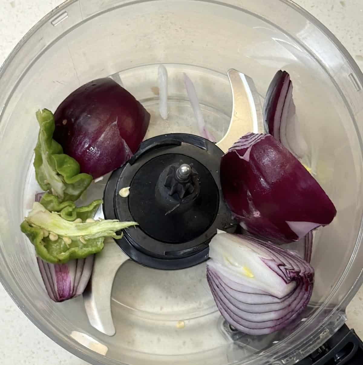 Onion ginger and green chilli in a chopper for poha cutlets