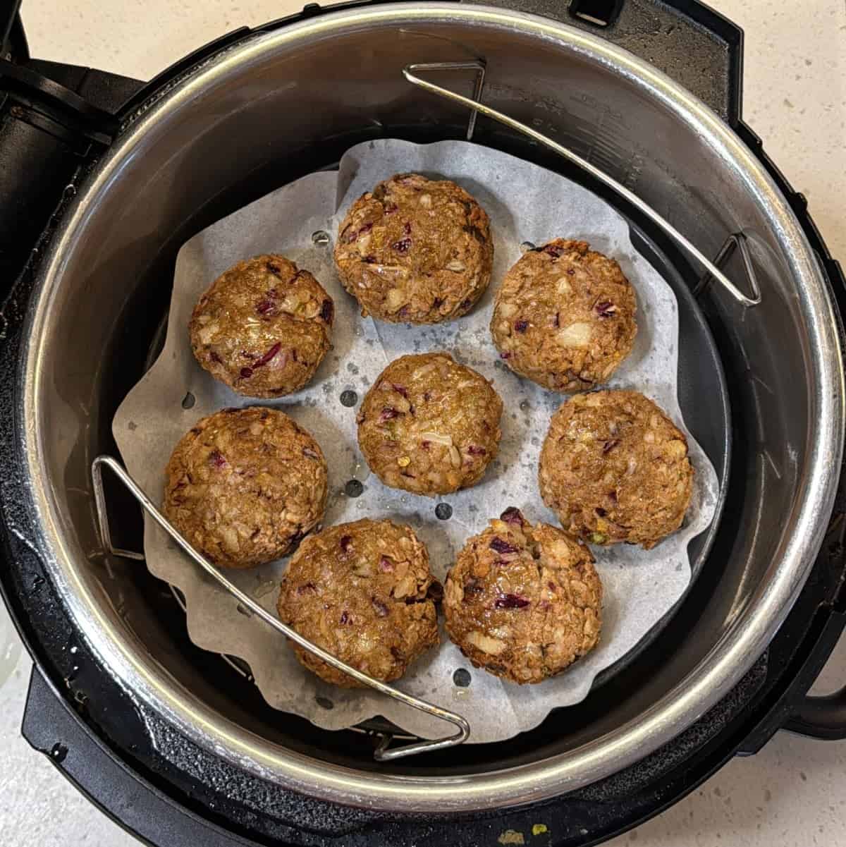 Poha cutlets brushed with oil in air fryer basket