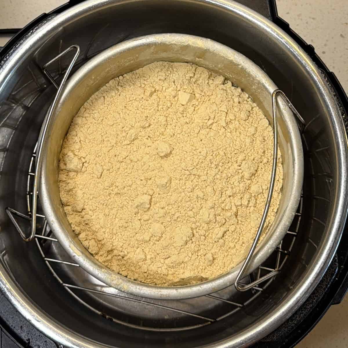 Sifted chana sattu in metal pan ready to dry roast in air fryer