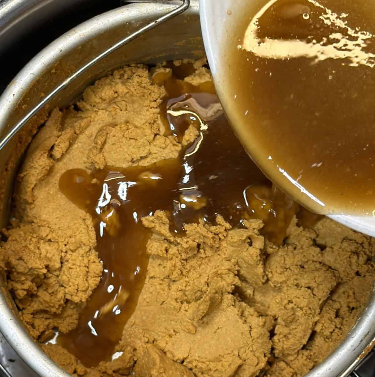 Sugar mixture poured into roasted sattu for air fryer burfi