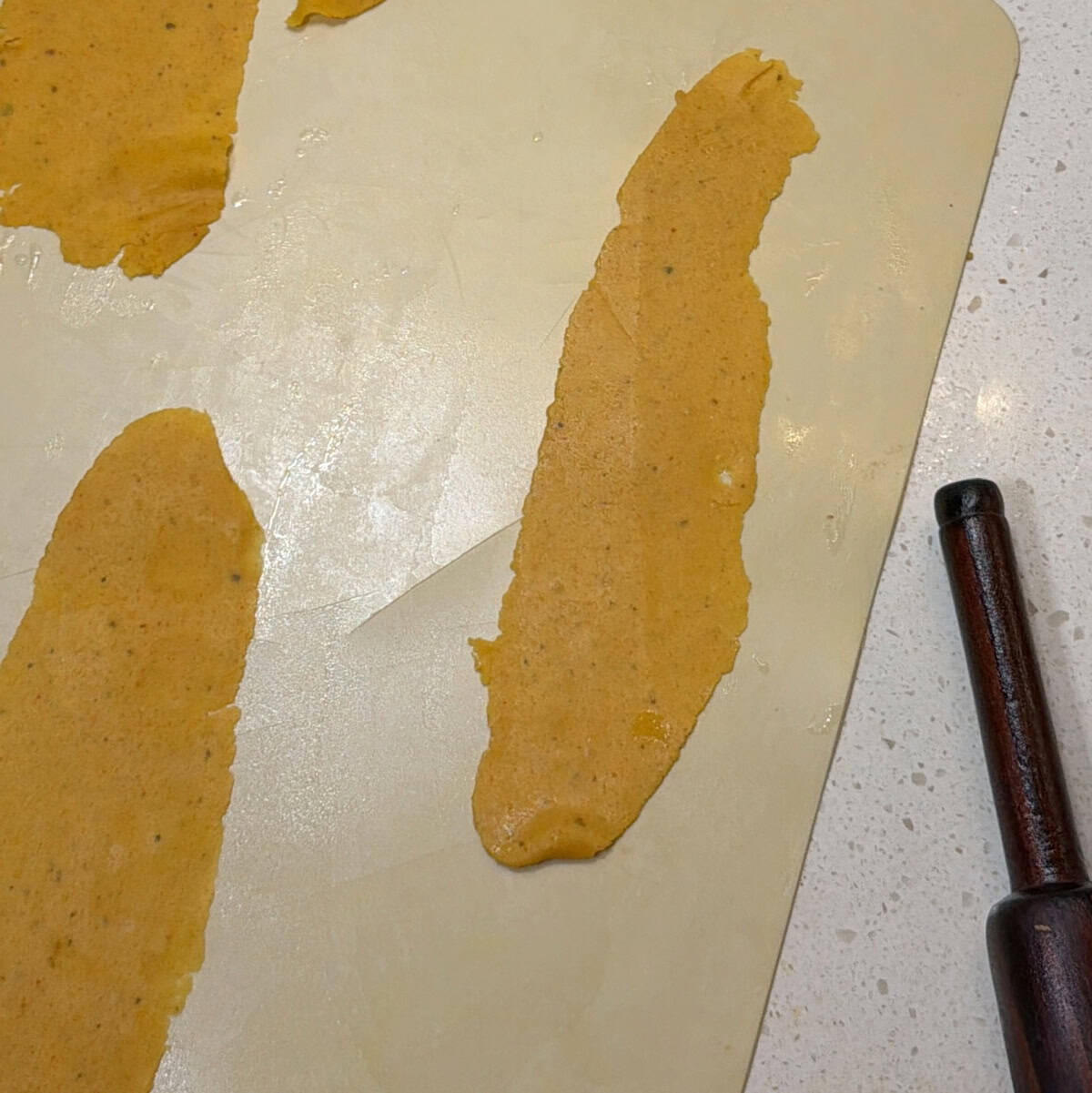 Long thin fafda strips shaped on rolling surface