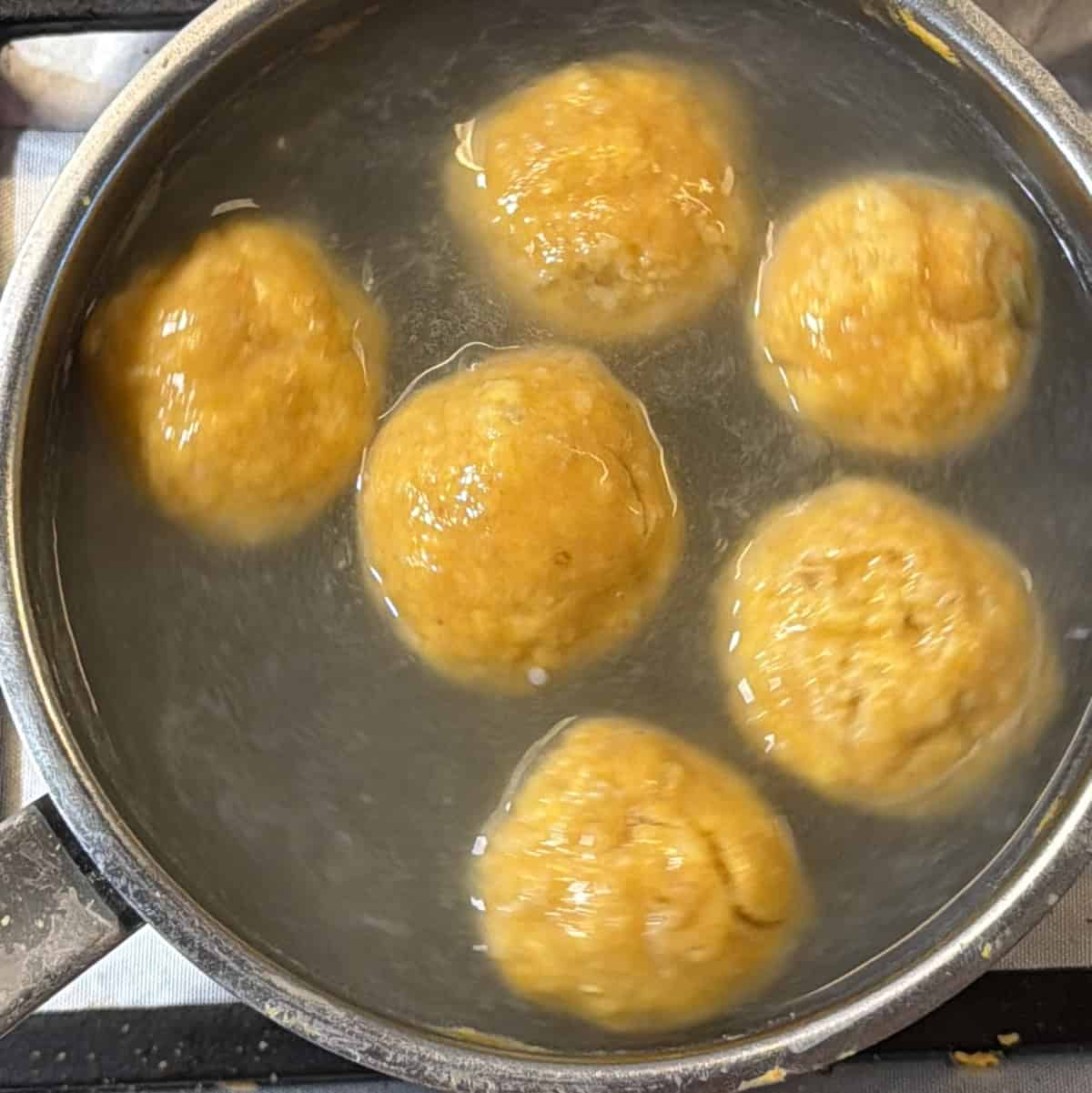 Fafda dough balls cooking in boiling water