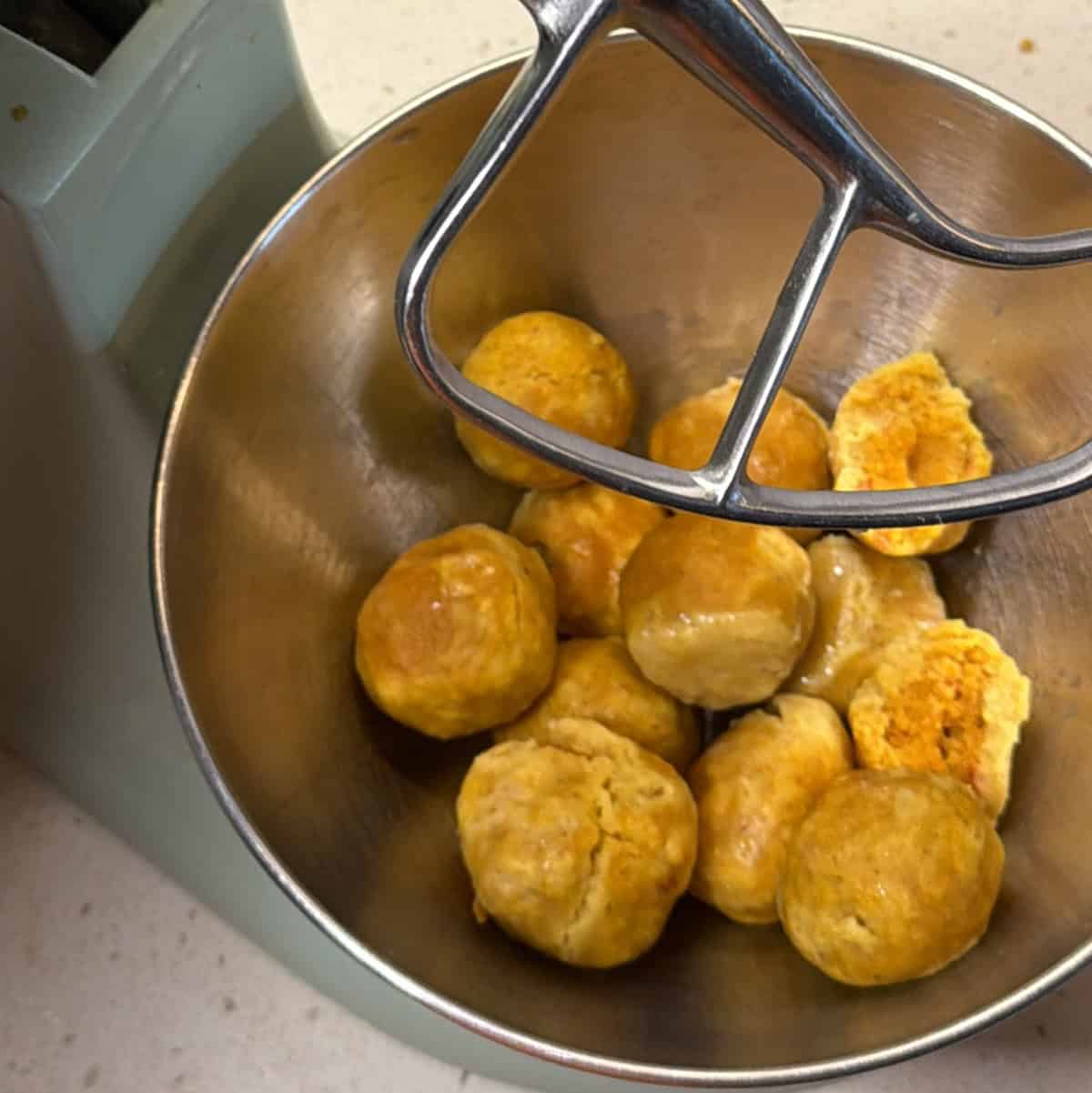 Boiled fafda dough balls ready to remove from saucepan