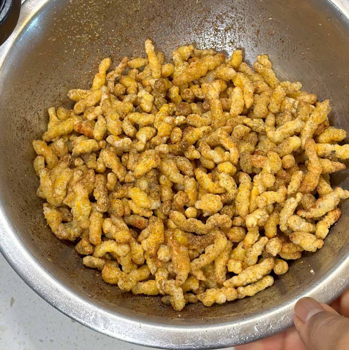 Seasoned puffed corn mixed with mint paprika and amchur