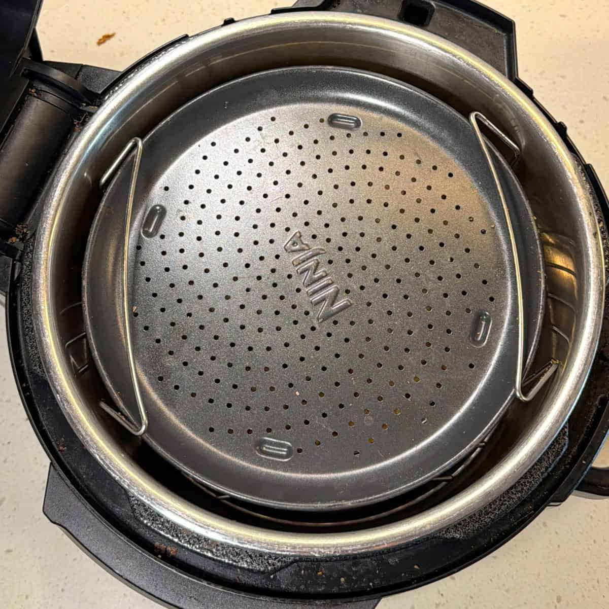 Puffed corn covered with perforated rack inside air fryer