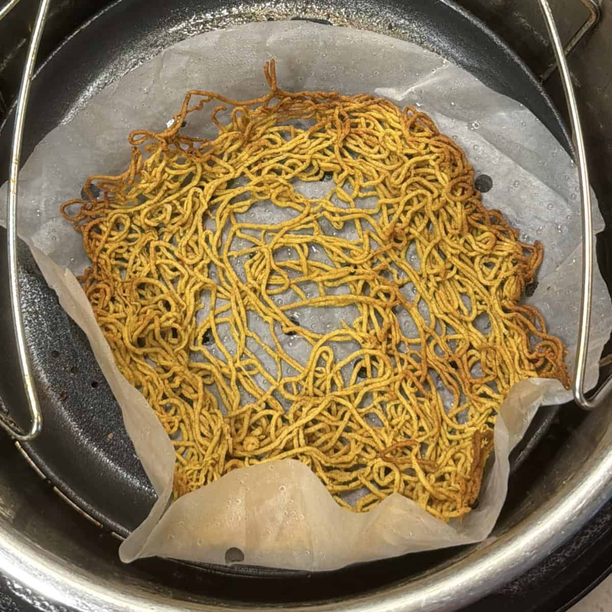 Cooked golden aloo bhujia on parchment