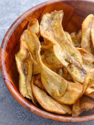Crispy homemade air fryer banana chips made from raw green bananas
