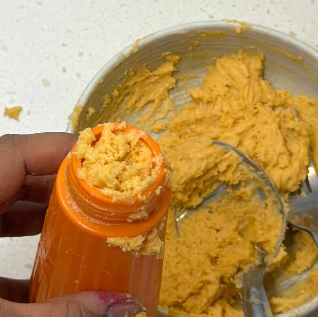 Jalebi dough being transferred into a piping bottle