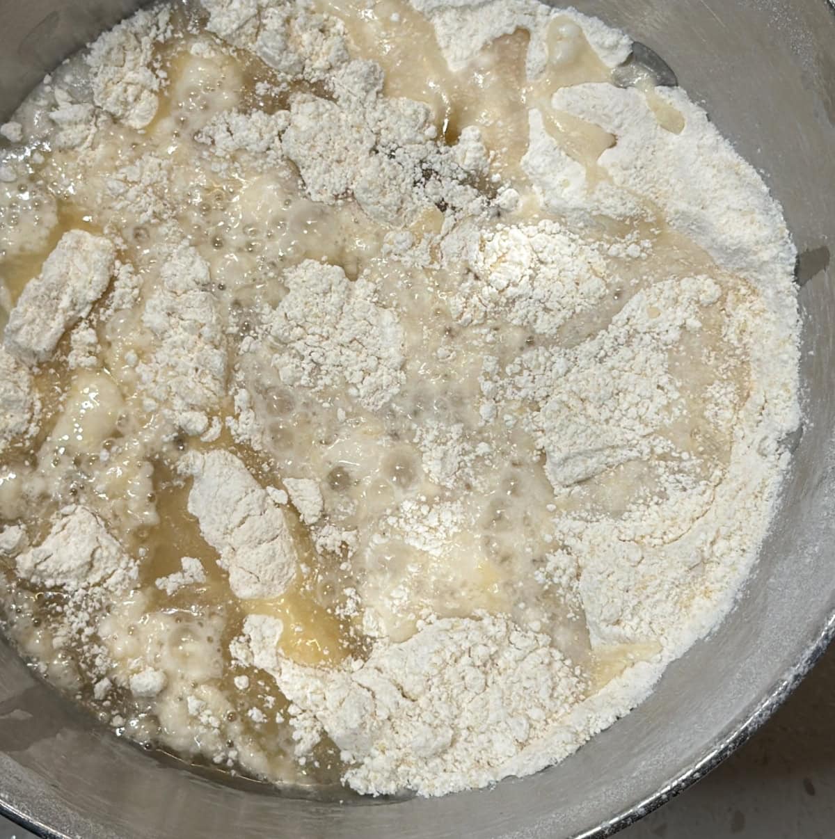 Water and oil added to the flour mixture for murukku dough