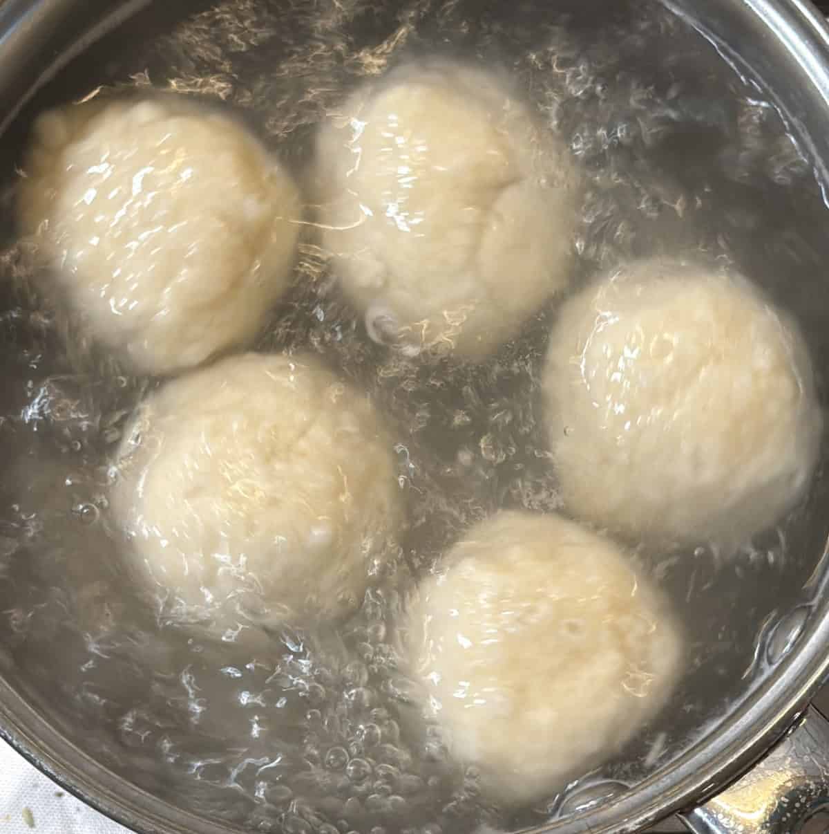Seedai dough balls boiling in a saucepan