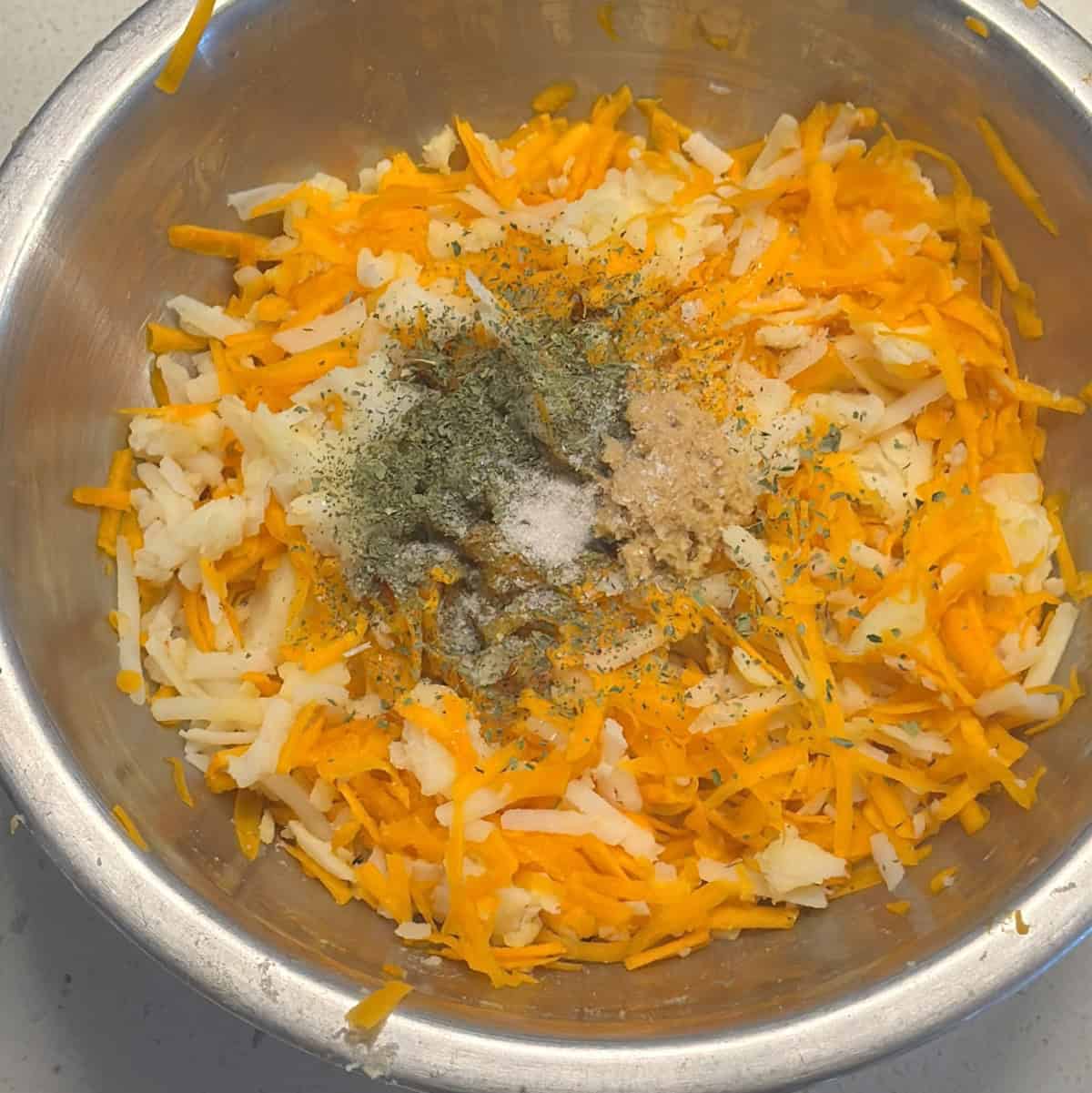 Mint and seasoning added to the carrot potato cutlet mixture