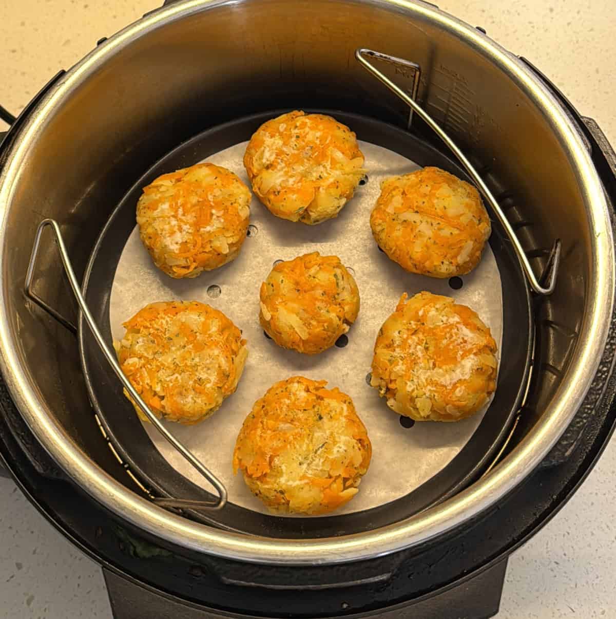 Carrot potato cutlets arranged in the air fryer basket