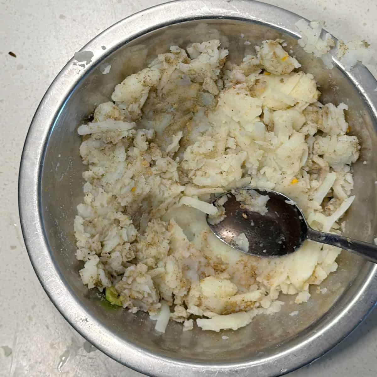 Grated boiled potato mixed with seasonings for millet cutlets
