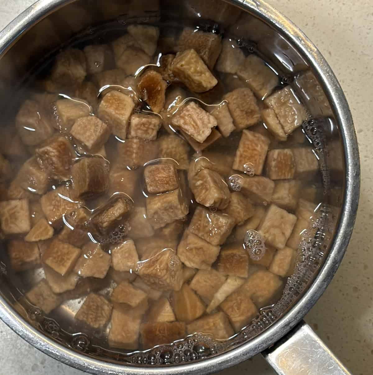 Chopped elephant yam soaking in hot water for yam cutlet recipe